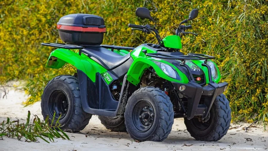 4x4 vehicle driving through water and muddy terrain in natural landscape