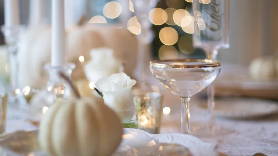 A beautifully set dining table with place settings and wine glasses, ready for an upscale meal