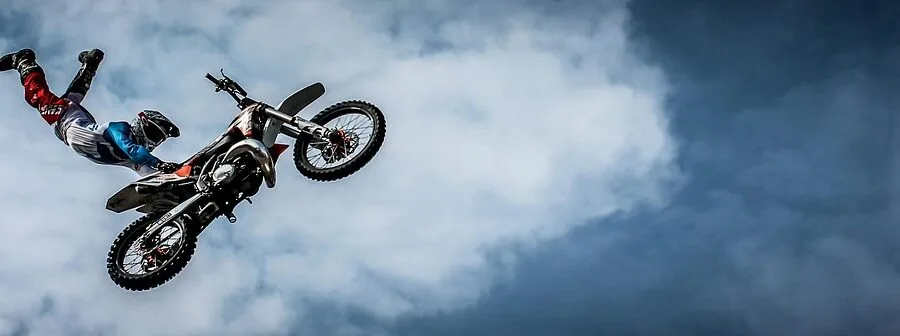 Action sports athlete performing in low-light evening conditions during outdoor adventure activity