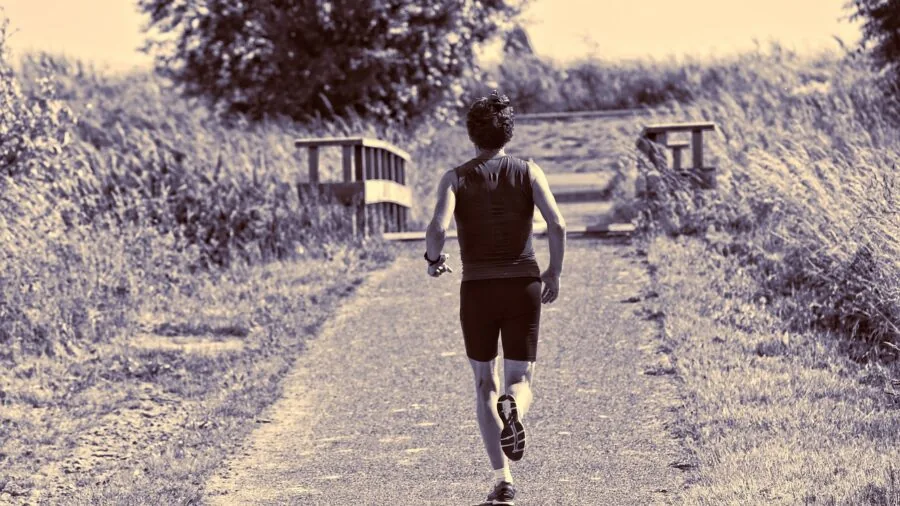 Active runner jogging outdoors during morning workout in natural daylight
