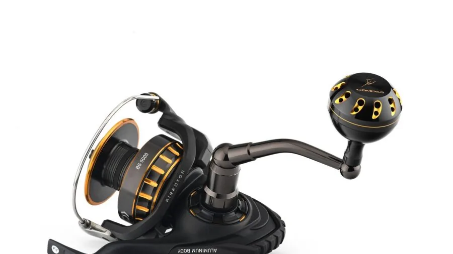 Angler turning fishing reel handle while casting from boat on water