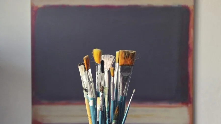 Artist preparing stretched canvas for painting in creative studio workspace