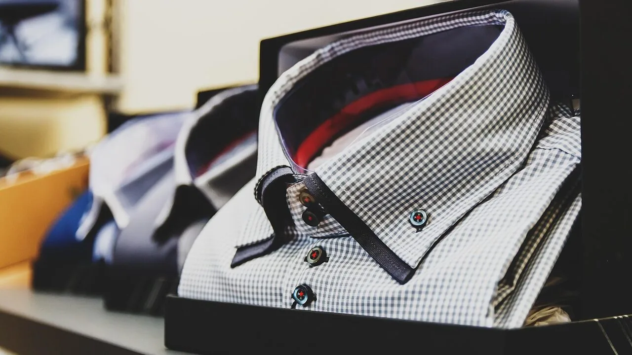 Assortment of men's flannel shirts in various plaid patterns folded neatly together