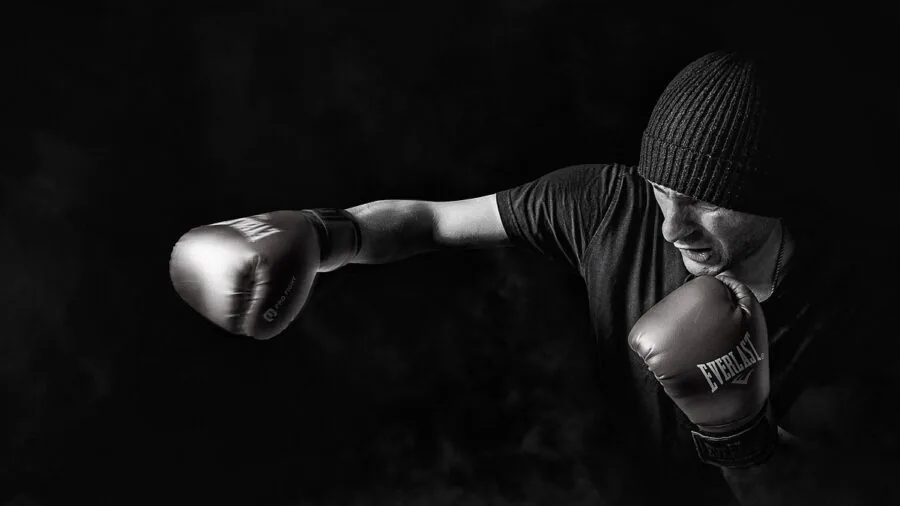 Athlete in moisture-wicking workout gear perspiring during vigorous training session