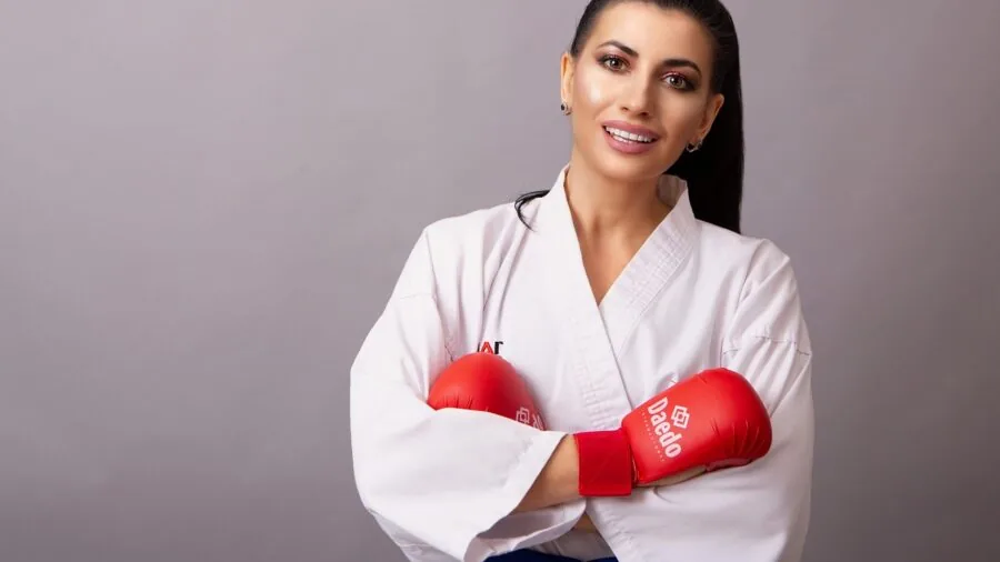 Athlete practicing boxing techniques in a modern gym environment with natural lighting