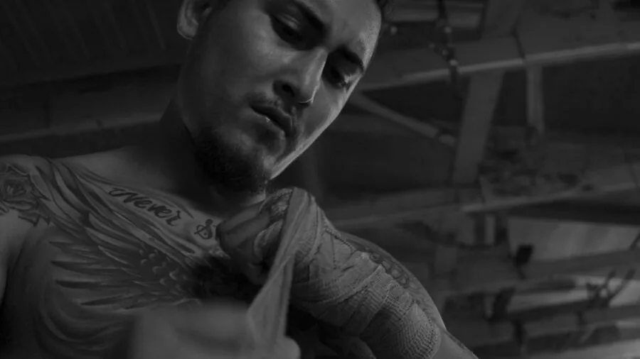 Athlete preparing hands with wraps before boxing session, close-up detail of hand protection