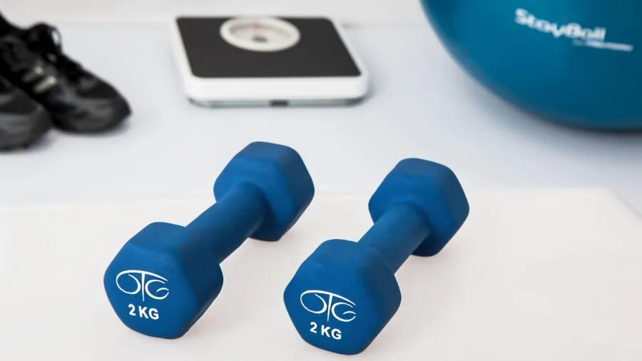 Athlete using versatile gym equipment with multiple attachment points during workout session