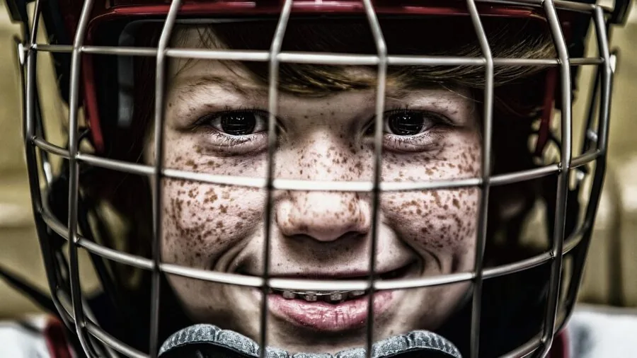 Athlete wearing protective gear while playing contact sport, demonstrating impact protection equipment in action