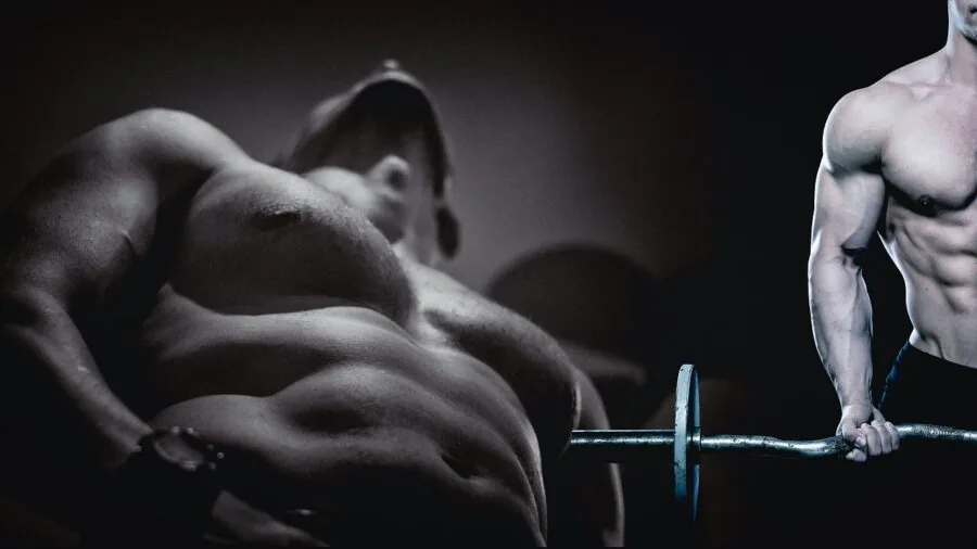 Athletic person performing bicep curls with barbell in gym setting, focused on arm exercise form and technique