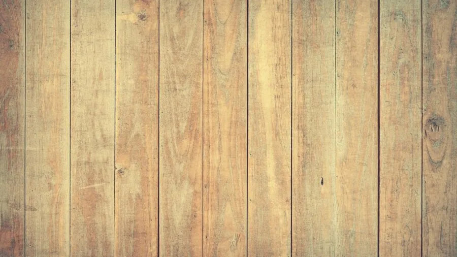 Athletic person practicing jump rope exercise on wooden gym floor indoors