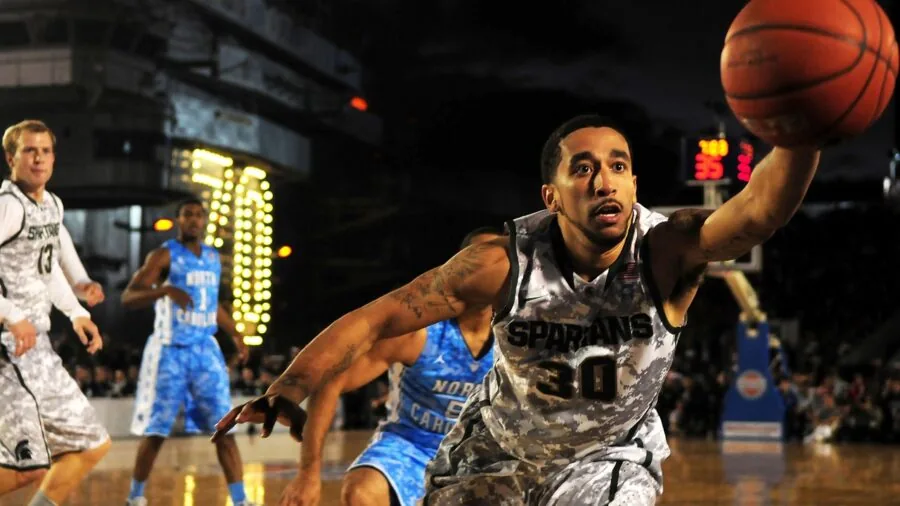 Athletic player performing dynamic dunk on outdoor court with force and power