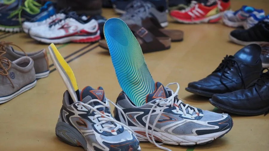 Athletic shoes air drying on wire rack with natural airflow and ventilation in home storage space