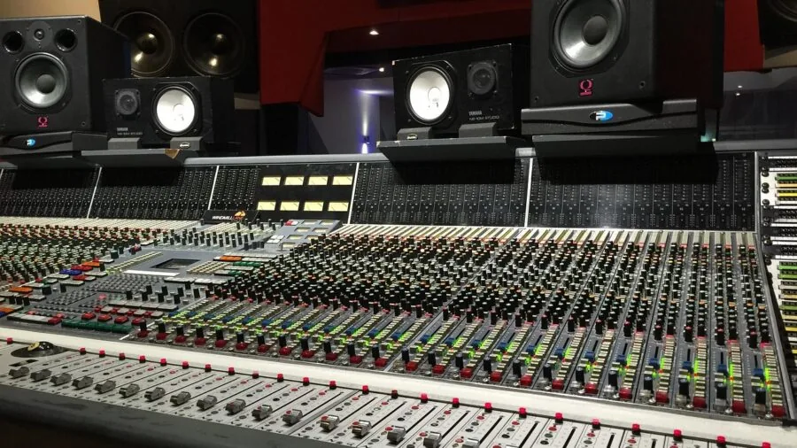 Audio engineer using sound measurement equipment in professional studio setting