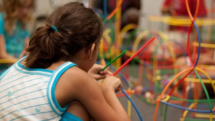 Baby engaging with colorful toys and activity panel, developing motor skills through play