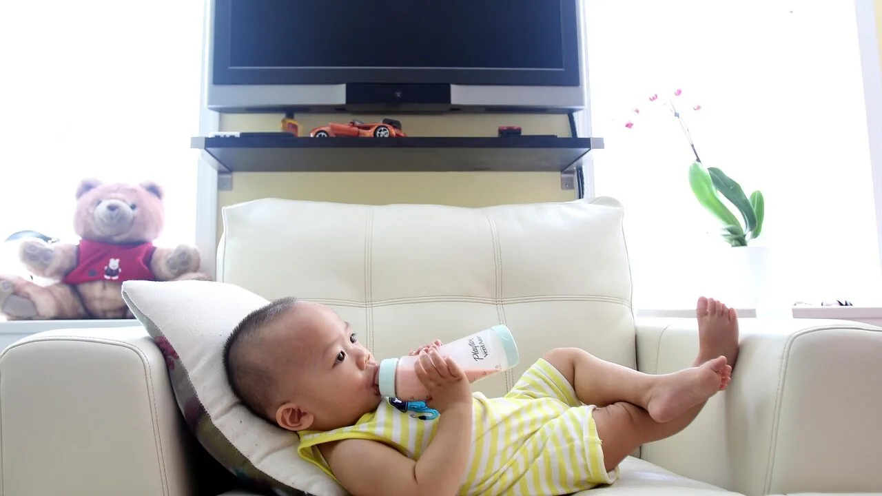 Baby formula dispenser with bottles and powder on white background