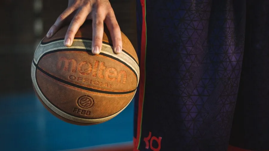 Basketball player shooting on outdoor court with strong wind conditions