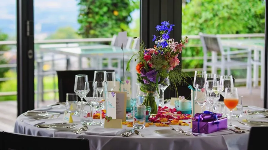 Beautifully arranged place setting with silverware and dinnerware on a wooden table