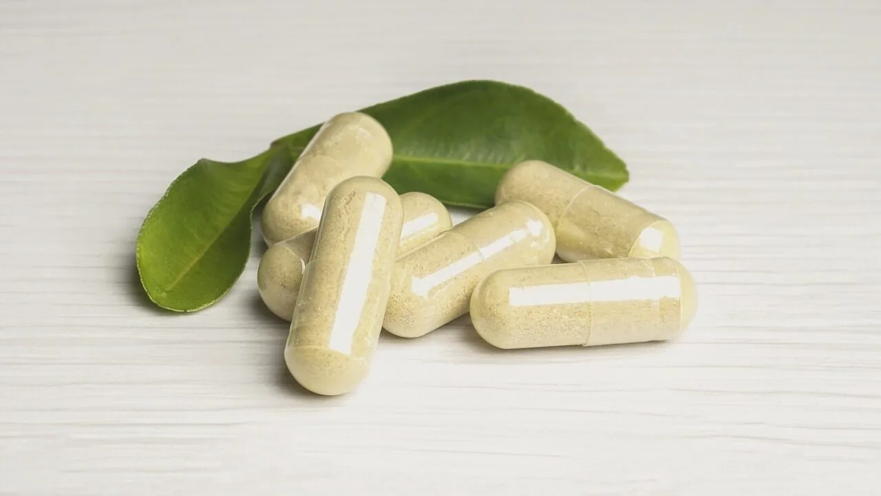 Bottles of prenatal vitamin supplements arranged on white surface