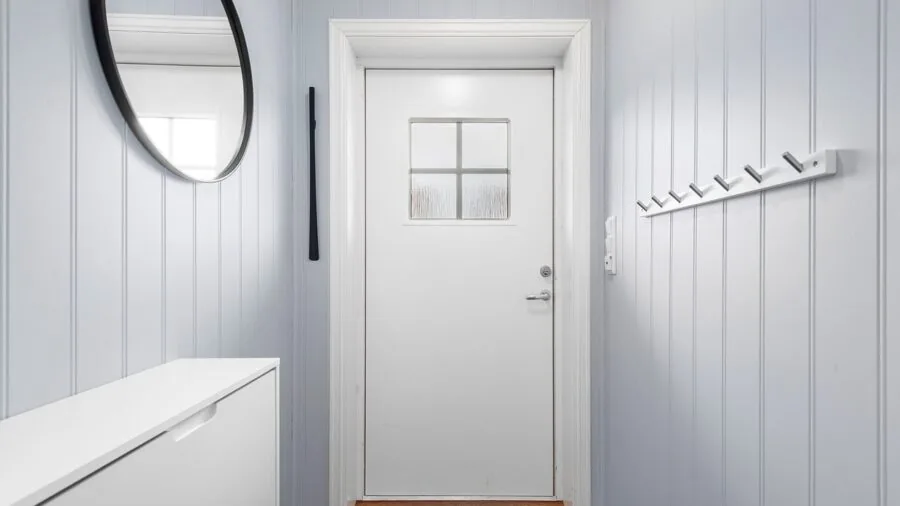 Bright entryway with console table styling and home decor accessories on neutral wall