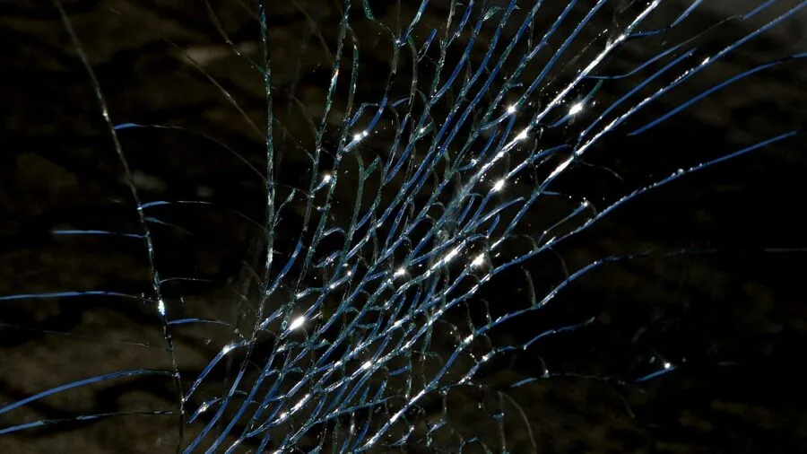 Broken glass scientific instrument on hard surface showing damage from accidental drop