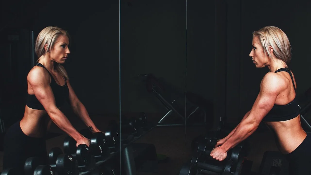 Cable machine with weight stack and handles in modern gym setting