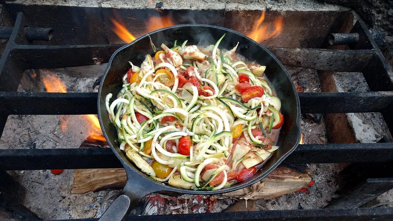 Camping cookware pots and pans set displayed outdoors in natural light