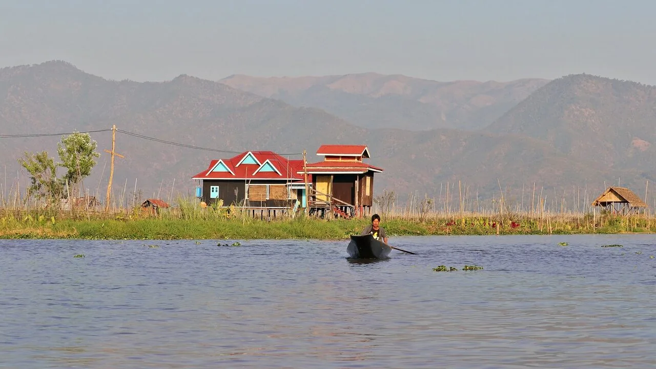 Canoe floating on calm lake water with natural scenery