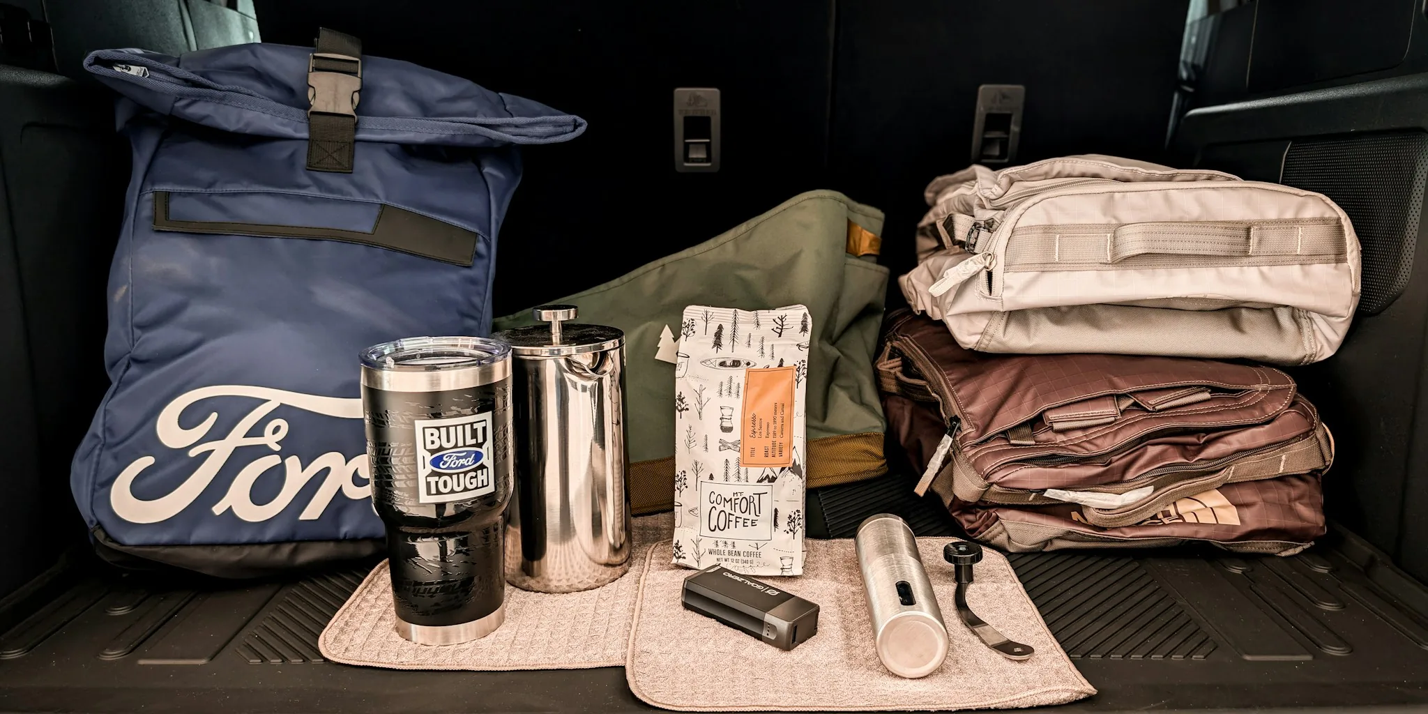 Car emergency kit with first aid, tools, and safety supplies displayed and organized