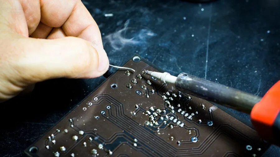 Careful hands working with precision tools in a well-organized workshop setting