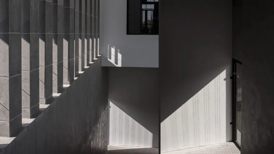 Cat passing through an open doorway into a home, demonstrating pet access and movement control
