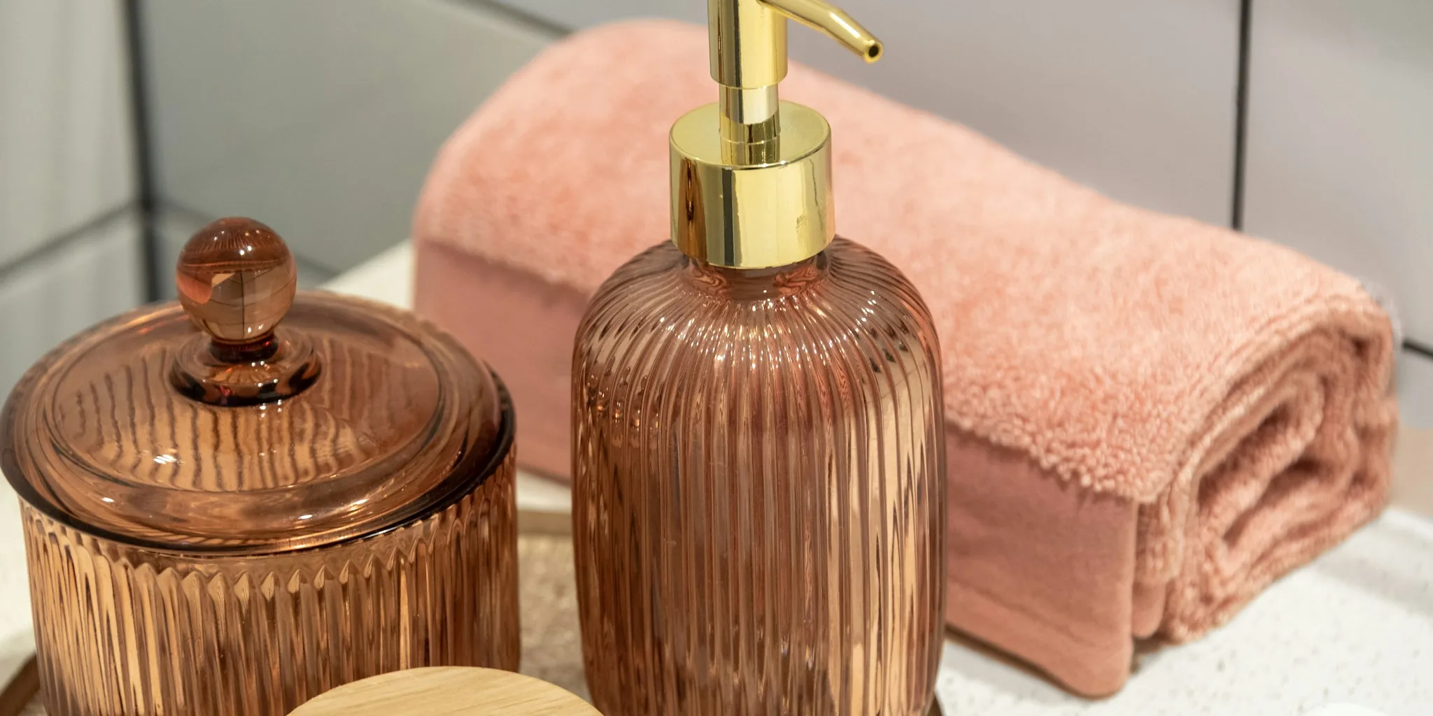 Cat shampoo bottles displayed on bathroom shelf with grooming supplies