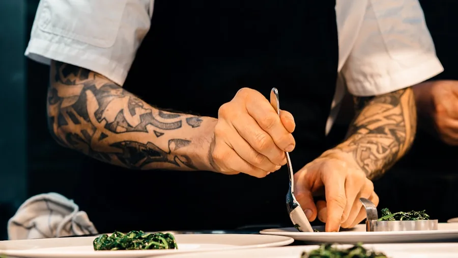 Chef cutting fresh vegetables on cutting board in bright kitchen
