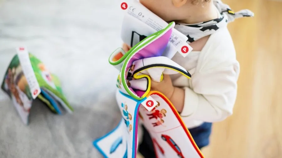 Child engaged in imaginative play in a dedicated playroom with organized toys and comfortable floor space