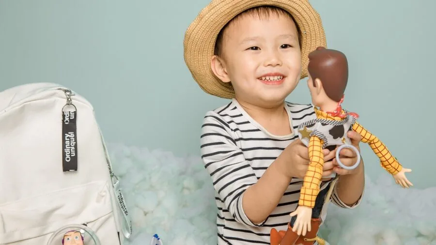 Child in navy cardigan sweater at school, lifestyle scene