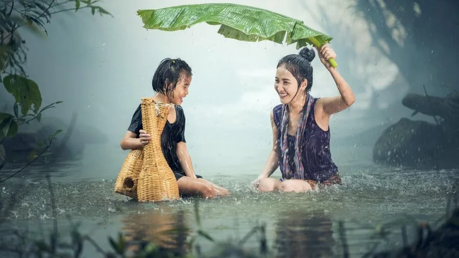 Child playing outdoors in snowy, wet winter weather conditions