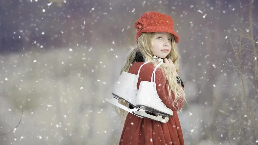 Child wearing winter coat playing outdoors in snow, showing active wear and tear