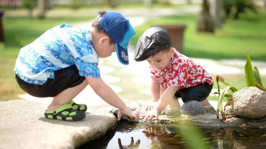 Children playing in a spacious backyard with clear open space around play equipment