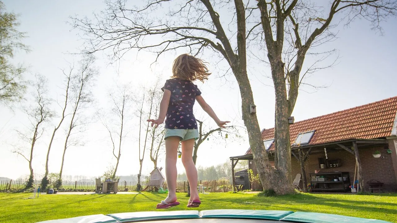 Children's trampoline set up in backyard for jumping and play