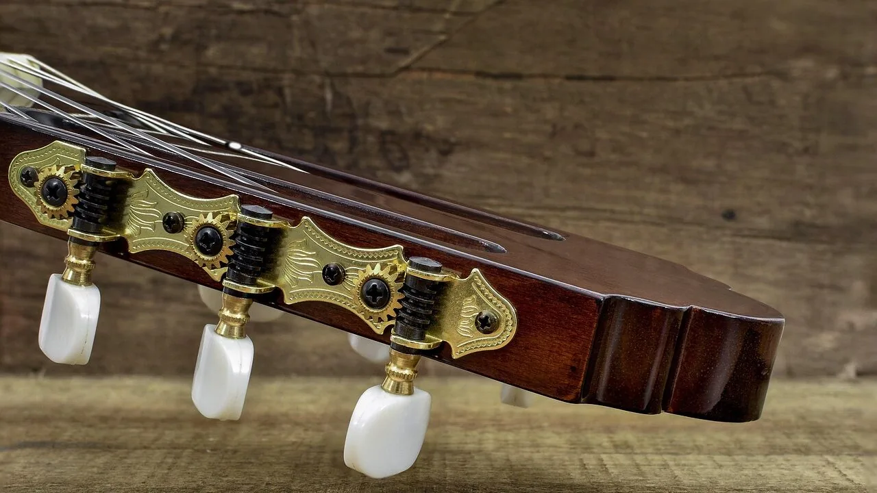 Classical guitar with wooden body and nylon strings in close detail