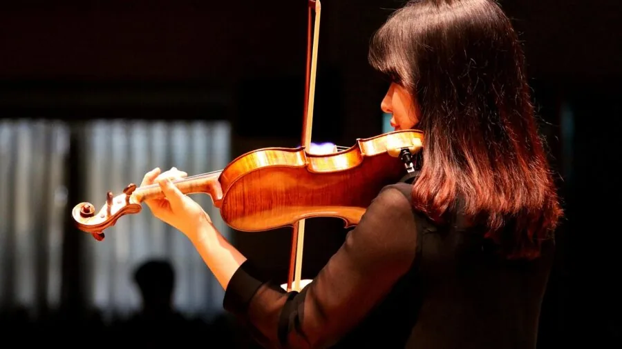 Classical musician performing clarinet with focused expression during live performance