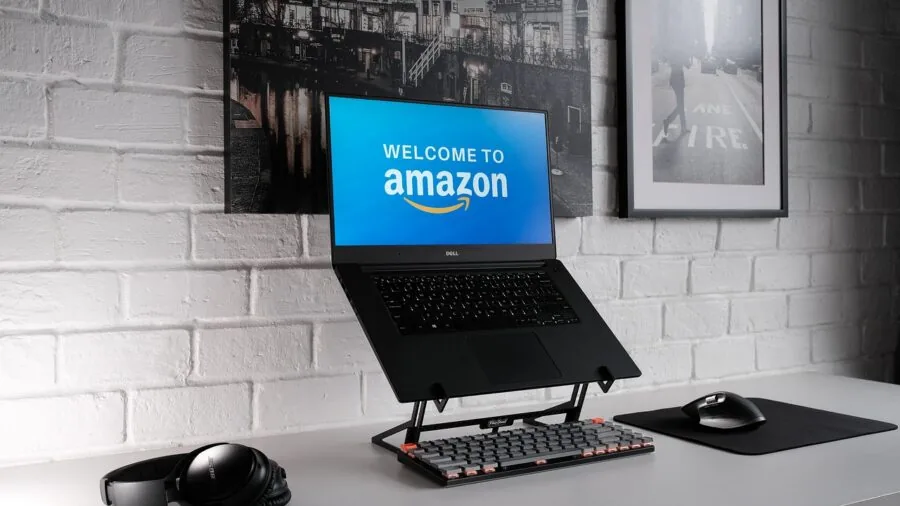 Clean minimalist desk workspace with monitor, keyboard, and organized office supplies for productive work environment