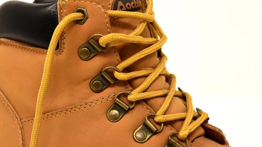 Close-up detail of genuine leather texture on a man's boot showing quality craftsmanship and material aging