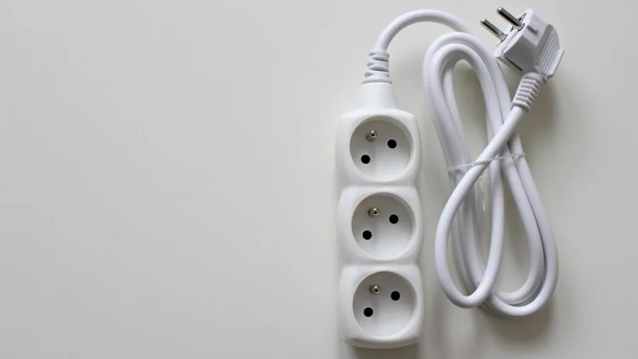 Close-up of a car's 12V power outlet with a device plugged in, showing electrical connection inside vehicle