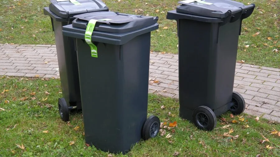 Close-up of a kitchen trash can with a tightly sealed lid to contain odors in a modern home kitchen