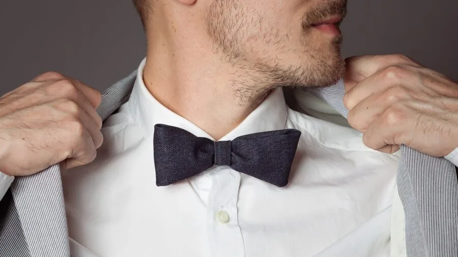 Close-up of a man's wrist wearing formal dress shirt with elegant cufflinks
