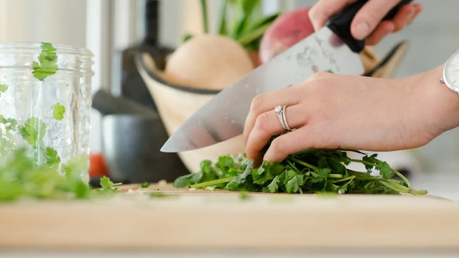 Close-up of a sharp chef knife slicing through fresh vegetables on a cutting board