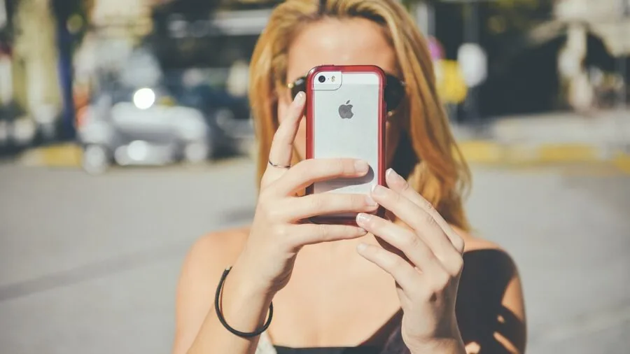 Close-up of a smartphone in a thick protective case, showing size and bulk considerations