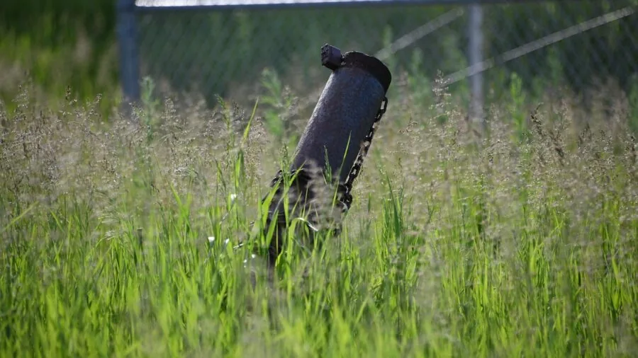 Close-up of a strong metal pole supporting outdoor volleyball net in sunlight