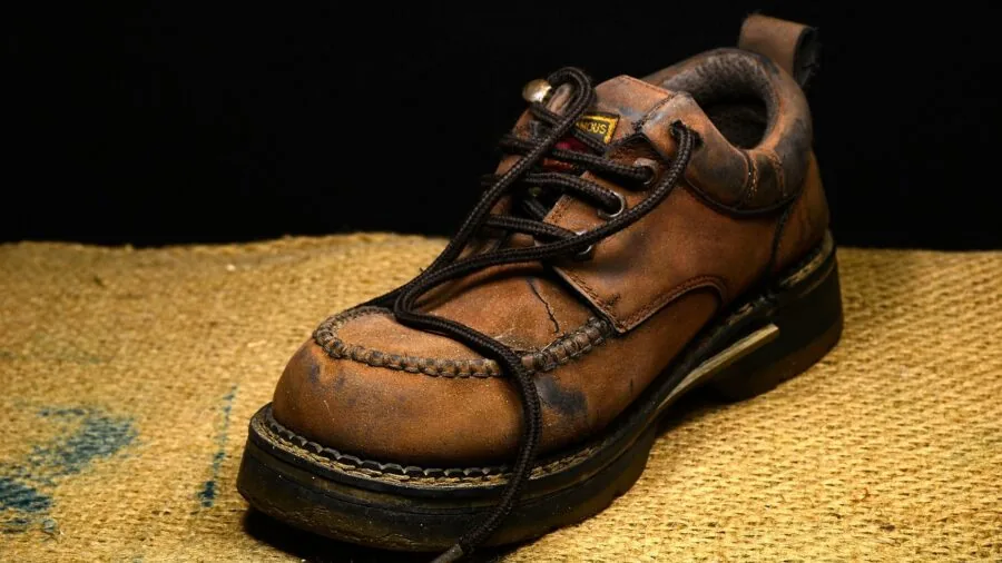 Close-up of aged full-grain leather showing natural patina and wear marks over time
