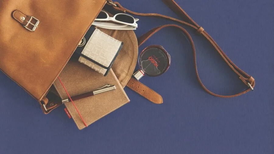 Close-up of aged leather wallet showing patina and wear from everyday use in back pocket